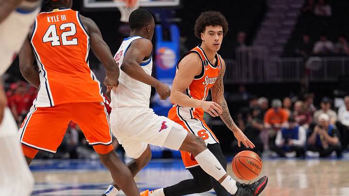 Mar 10, 2026; Charlotte, NC, USA; Syracuse Orange guard Naithan George (11) dribbles against Southern Methodist University Mustangs guard Boopie Miller (2) during the second half at Spectrum Center. Mandatory Credit: Jim Dedmon-Imagn Images