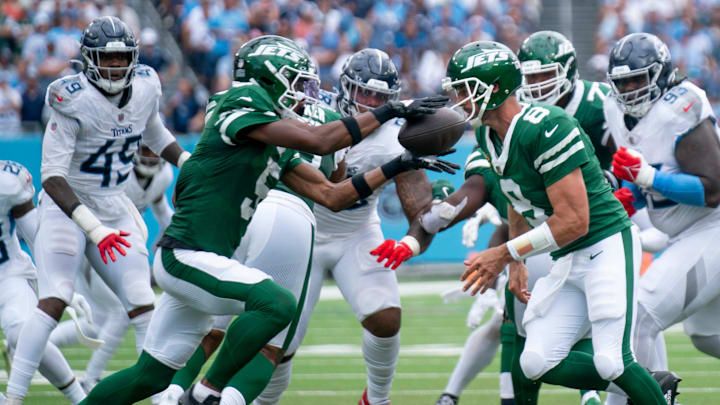 New York Jets quarterback Aaron Rodgers (8) pitches the ball to New York Jets wide receiver Garrett Wilson (5) during their game against the Tennessee Titans at Nissan Stadium in Nashville, Tenn., Sunday, Sept. 15, 2024.
