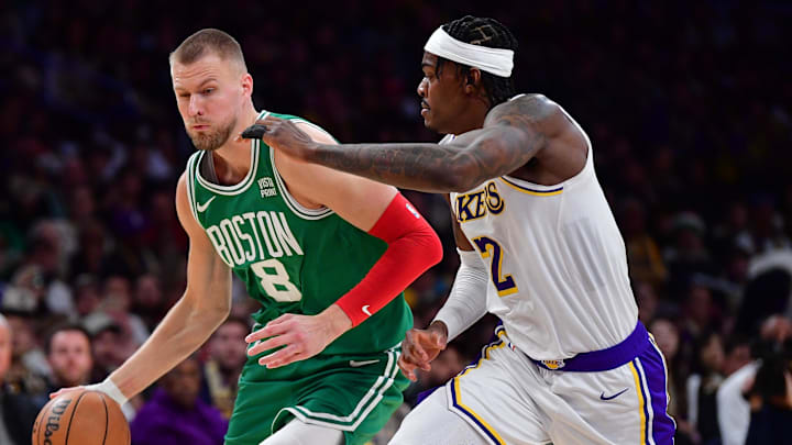 Dec 25, 2023; Los Angeles, California, USA; Boston Celtics center Kristaps Porzingis (8) moves to the basket against Los Angeles Lakers forward Jarred Vanderbilt (2) during the second half at Crypto.com Arena. Mandatory Credit: Gary A. Vasquez-Imagn Images