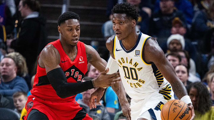 Feb 26, 2025; Indianapolis, Indiana, USA; Indiana Pacers guard Bennedict Mathurin (00) dribbles the ball while Toronto Raptors guard RJ Barrett (9) defends in the first half at Gainbridge Fieldhouse. Mandatory Credit: Trevor Ruszkowski-Imagn Images