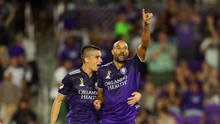 Sep 17, 2022; Orlando, Florida, USA;  Orlando City defender Joao Moutinho (4) congratulates forward Tesho Akindele.