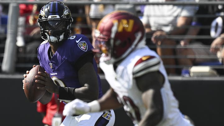 Baltimore Ravens quarterback Lamar Jackson (8) looks to pass as Washington Commanders safety Quan Martin (20) drops back in coverage during the first half at M&T Bank Stadium. 