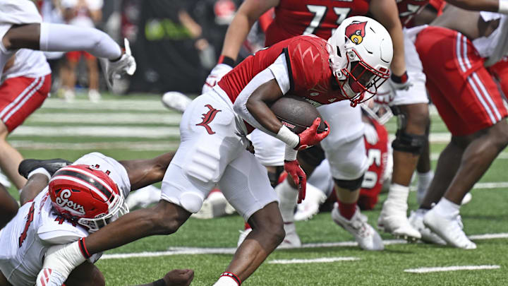 Aug 31, 2024; Louisville, Kentucky, USA;  Louisville Cardinals running back Duke Watson (26) avoids the tackle of Austin Peay Governors linebacker Dion Hunter (44) to run for a touchdown during the second half at L&N Federal Credit Union Stadium. Louisville defeated Austin Peay 62-0. Mandatory Credit: Jamie Rhodes-USA TODAY Sports