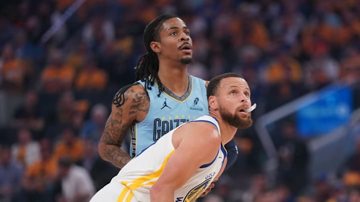 Apr 15, 2025; San Francisco, California, USA; Golden State Warriors guard Stephen Curry (30) stands in front of Memphis Grizzlies guard Ja Morant (12) during a jump ball in the first quarter at the Chase Center. Mandatory Credit: Cary Edmondson-Imagn Images