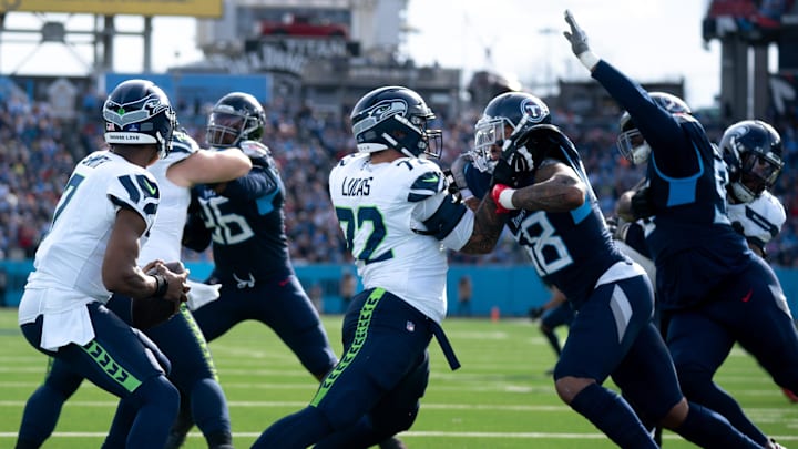 Seattle Seahawks offensive tackle Abraham Lucas (72) and Tennessee Titans linebacker Harold Landry III (58) battle during their game at Nissan Stadium in Nashville, Tenn., Sunday, Dec. 24, 2023.