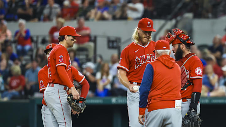 Angels manager Joe Maddon (70) removes starting pitcher Noah Syndergaard (34) during the first inning against the Texas Rangers at Globe Life Field on May 16, 2022.
