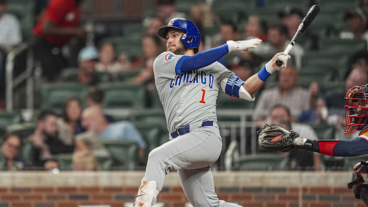 May 14, 2024; Cumberland, Georgia, USA; Chicago Cubs second baseman Nick Madrigal (1) singles against the Atlanta Braves during the seventh inning at Truist Park. Mandatory Credit: Dale Zanine-Imagn Images