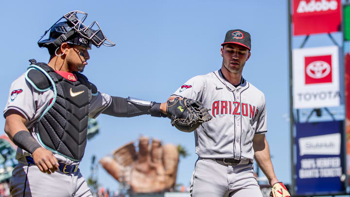 Apr 21, 2024; San Francisco, California, USA;  Arizona Diamondbacks pitcher Bryce Jarvis (40) and catcher Gabriel Moreno (14) fist-bump after ending the inning with the bases loaded during the seventh inning of the game against the San Francisco Giants at Oracle Park. Mandatory Credit: John Hefti-USA TODAY Sports