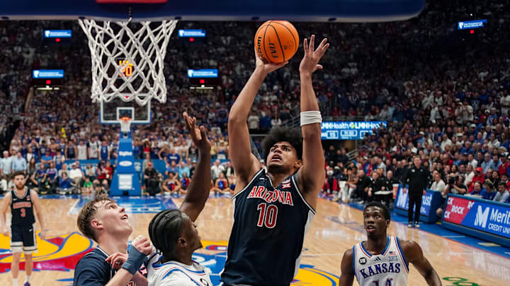 Feb 9, 2026; Lawrence, Kansas, USA; Arizona Wildcats forward Koa Peat (10) shoots against Kansas Jayhawks forward Flory Bidunga (40) during the first half at Allen Fieldhouse. Mandatory Credit: Jay Biggerstaff-Imagn Images