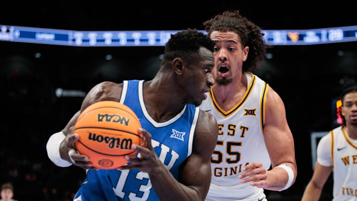 Mar 11, 2026; Kansas City, MO, USA; BYU Cougars forward Keba Keita (13) drives to the basket around West Virginia Mountaineers center Harlan Obioha (55) during the second half at T-Mobile Center. Mandatory Credit: William Purnell-Imagn Images