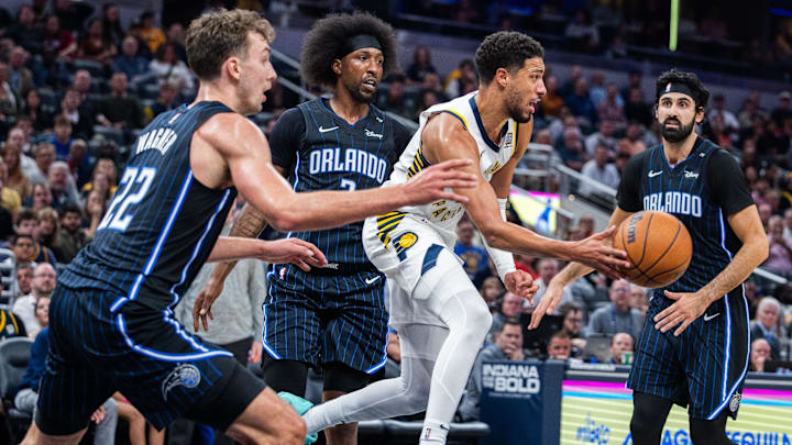 Nov 6, 2024; Indianapolis, Indiana, USA; Indiana Pacers guard Tyrese Haliburton (0) passes the ball while  Orlando Magic forward Franz Wagner (22) defends in the first half at Gainbridge Fieldhouse. Mandatory Credit: Trevor Ruszkowski-Imagn Images