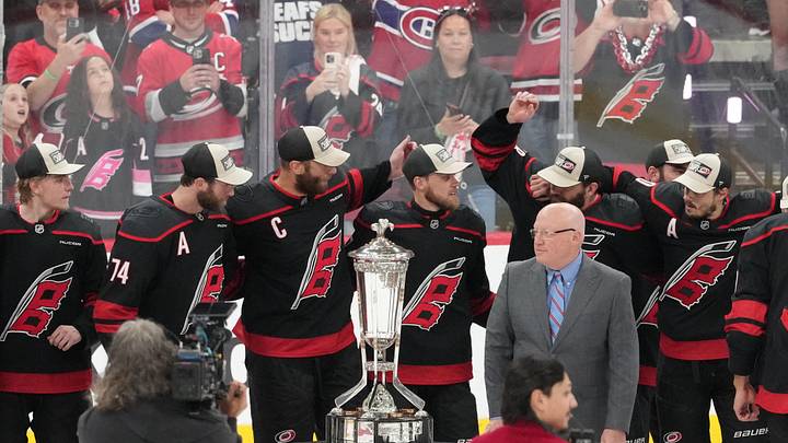 May 29, 2026; Raleigh, North Carolina, USA; NHL deputy commissioner Bill Daly (right) and the Carolina Hurricanes pose for a photo with the Prince of Wales Trophy after Carolina defeated the Montreal Canadiens in game five of the Eastern Conference Final of the 2026 Stanley Cup Playoffs at Lenovo Center. Mandatory Credit: James Guillory-Imagn Images