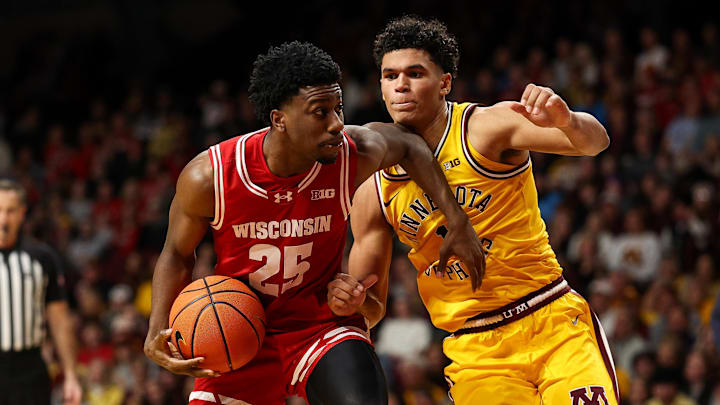 Jan 13, 2026; Minneapolis, Minnesota, USA; Wisconsin Badgers guard John Blackwell (25) works around Minnesota Golden Gophers guard Isaac Asuma (1) during the second half at Williams Arena.