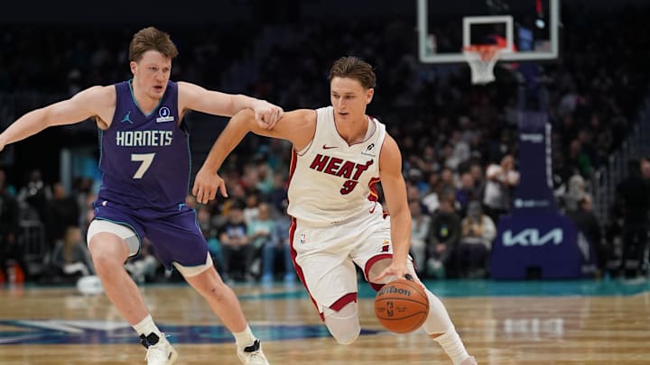 Miami Heat guard Pelle Larsson (9) drives to the basket against Charlotte Hornets guard Kon Knueppel 