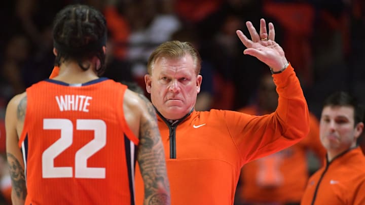 Feb 25, 2025; Champaign, Illinois, USA;  Illinois Fighting Illini head coach Brad Underwood reacts with player Illinois Fighting Illini guard Tre White (22)  during the second half at State Farm Center. Mandatory Credit: Ron Johnson-Imagn Images