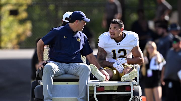 Sep 14, 2024; West Lafayette, Indiana, USA; Notre Dame Fighting Irish defensive lineman Jordan Botelho (12) is carted off the field with an apparent injury during the second quarter against the Purdue Boilermakers at Ross-Ade Stadium. 