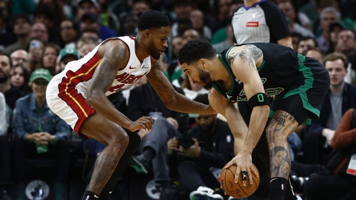 May 1, 2024; Boston, Massachusetts, USA; Boston Celtics forward Jayson Tatum (0) looks for a way against Miami Heat's Tyler Herro - Winslow Townson/USA TODAY Sports
