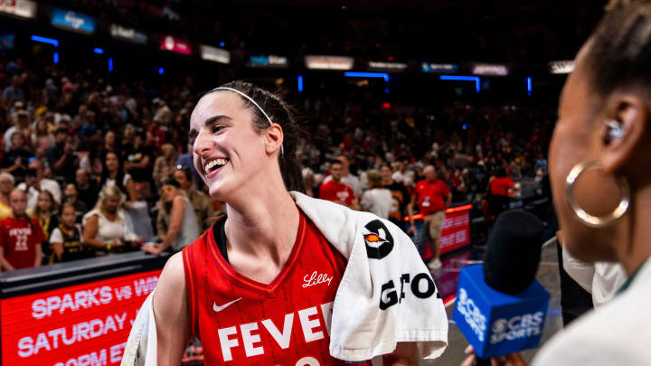 Jul 6, 2024; Indianapolis, Indiana, USA; Indiana Fever guard Caitlin Clark (22) smiles in an interview after becoming the first rookie to have a triple-double during a game against the New York Liberty at Gainbridge Fieldhouse.