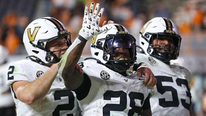 Nov 29, 2025; Knoxville, Tennessee, USA;  Vanderbilt Commodores quarterback Diego Pavia (2), running back Sedrick Alexander (28) and offensive lineman Jordan White (53) celebrate a touchdown against the Tennessee Volunteers during the second half at Neyland Stadium. Mandatory Credit: Randy Sartin-Imagn Images