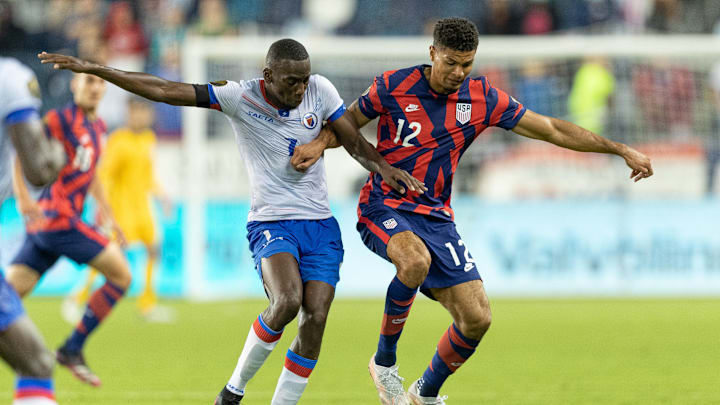 Miles Robinson shields the ball from a Haitian player during the 2021 Gold Cup.