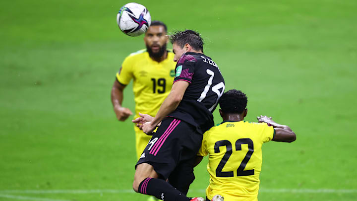 Sebastián Córdova en la pelea de un balón ante la marca de dos jamaiquinos.