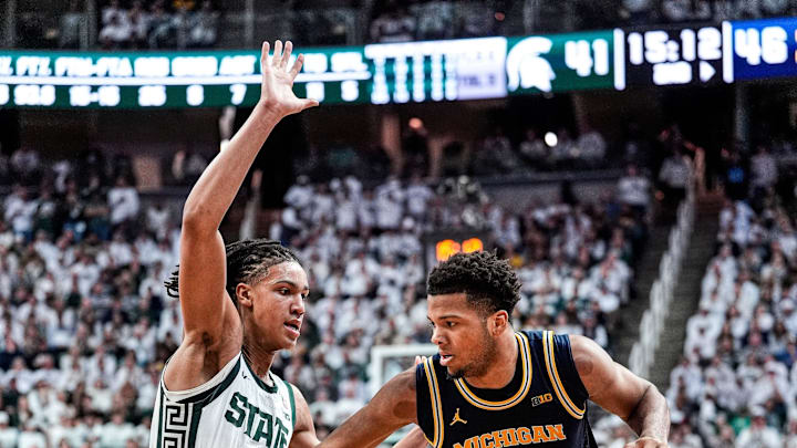 Michigan guard Trey McKenney (1) dribbles against Michigan State forward Jordan Scott (6) during the second half at Breslin Center in East Lansing on Friday, Jan. 30, 2026.