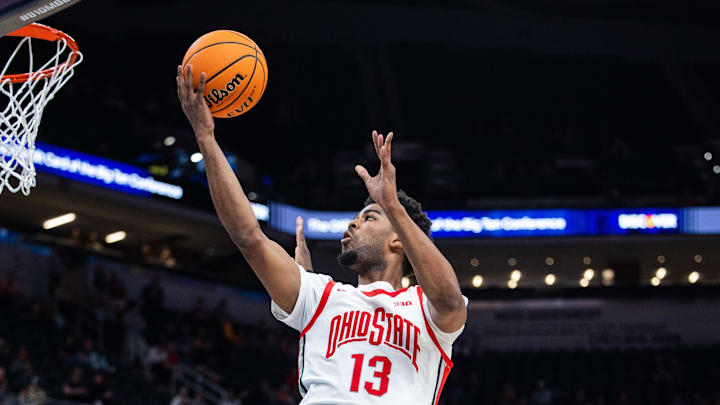 Mar 12, 2025; Indianapolis, IN, USA; Ohio State Buckeyes forward Sean Stewart (13) shoots the ball while Iowa Hawkeyes forward Ladji Dembele (13) defends in the second half  at Gainbridge Fieldhouse. Mandatory Credit: Trevor Ruszkowski-Imagn Images
