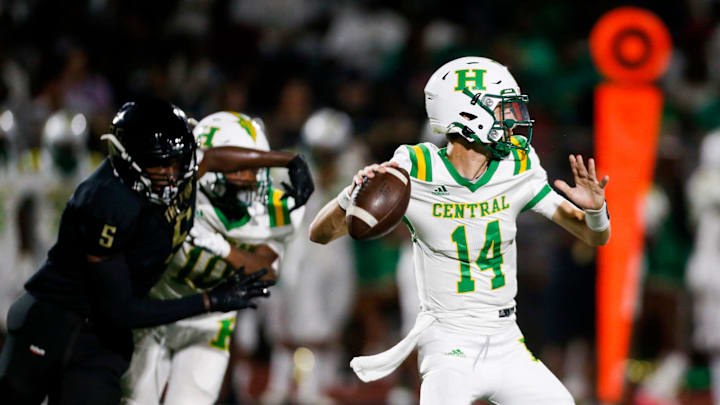 Central   s Hays Wright (14) looks to throw the ball as Whitehaven   s Cory House (5) runs up behind him looking for a sack during the game between Memphis Central High School and Whitehaven High School at the Whitehaven Classic in Memphis, Tenn., on Saturday, August 19, 2023. Whitehaven defeated Central 40-13.