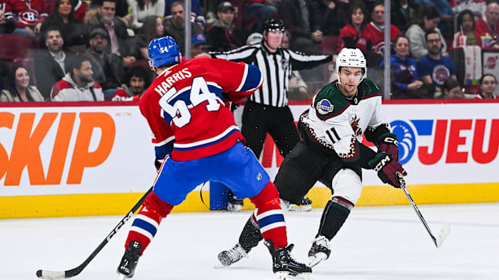 Feb 27, 2024; Montreal, Quebec, CAN; Arizona Coyotes right wing Dylan Guenther (11) plays the puck