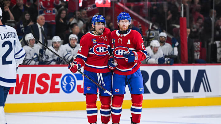 Montreal, Quebec, CAN; Montreal Canadiens defenseman Mike Matheson celebrates a goal with center Nick Suzuki against the Toronto Maple Leafs during the first period at Bell Centre. Credit: David Kirouac-Imagn Images