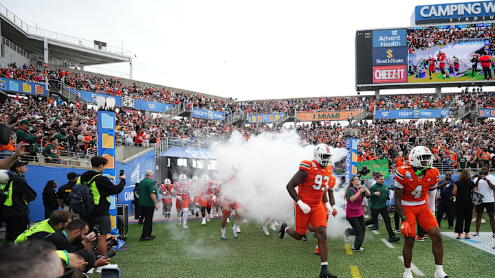 Dec 28, 2024; Orlando, FL, USA; The Miami Hurricanes take the field prior to the game against the Iowa State Cyclones at Camping World Stadium. Mandatory Credit: Jasen Vinlove-Imagn Images