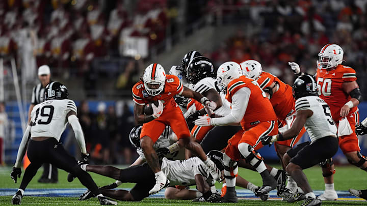 Dec 28, 2024; Orlando, FL, USA; Miami Hurricanes running back Damien Martinez (6) runs the back against the Iowa State Cyclones during the second half at Camping World Stadium. Mandatory Credit: Jasen Vinlove-Imagn Images