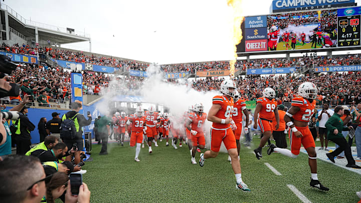 Dec 28, 2024; Orlando, FL, USA; The Miami Hurricanes take the field prior to the game against the Iowa State Cyclones at Camping World Stadium. Mandatory Credit: Jasen Vinlove-Imagn Images