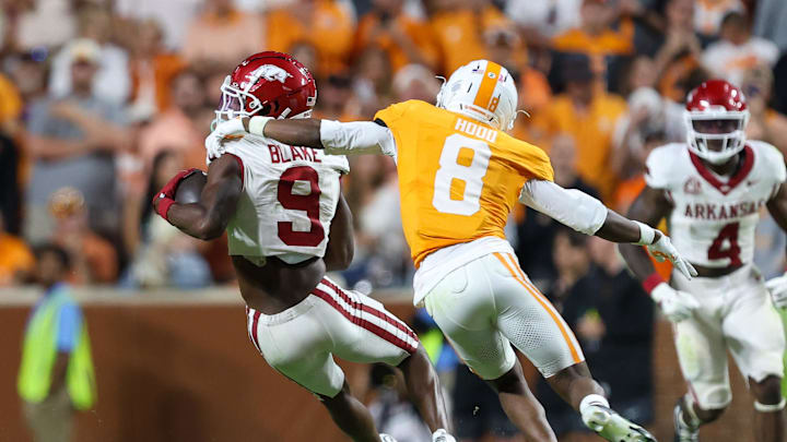 Oct 11, 2025; Knoxville, Tennessee, USA; Arkansas Razorbacks wide receiver O'Mega Blake (9) runs the ball against Tennessee Volunteers defensive back Colton Hood (8) during the second half at Neyland Stadium. Mandatory Credit: Randy Sartin-Imagn Images