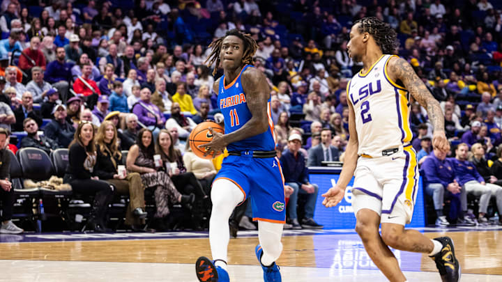 Feb 22, 2025; Baton Rouge, Louisiana, USA;  Florida Gators guard Denzel Aberdeen (11) drives to the basket against LSU Tigers guard Mike Williams III (2) during the second half at Pete Maravich Assembly Center. Mandatory Credit: Stephen Lew-Imagn Images