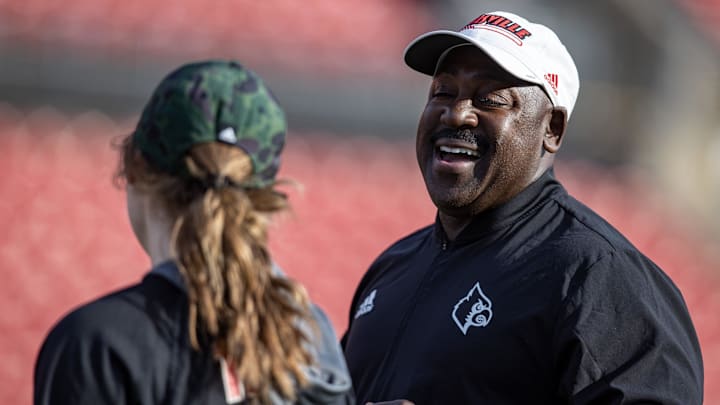 Co-defensive coordinator, Wesley McGriff, right, has a laugh during U of L's first spring football