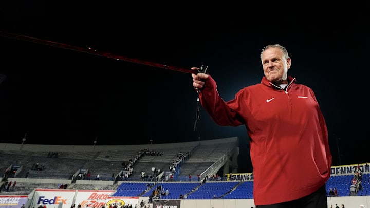 Arkansas' head coach Sam Pittman points to his players and Arkansas fans with his cane after Arkansas defeated Texas Tech 36-26 in the AutoZone Liberty Bowl in Memphis, Tenn., on Friday, December 27, 2024.