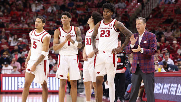 Dec 16, 2025; Fayetteville, Arkansas, USA; Arkansas Razorbacks head coach John Calipari talks to forward Nick Pringle (23), along with guards Meleek Thomas (1) and Darius Acuff Jr (5) during the second half against the Queens Royals at Bud Walton Arena. Arkansas won 108-80. Mandatory Credit: Nelson Chenault-Imagn Images Dec 16, 2025; Fayetteville, Arkansas, USA; Arkansas Razorbacks head coach John Calipari talks to forward Nick Pringle (23), along with guards Meleek Thomas (1) and Darius Acuff Jr (5) during the second half against the Queens Royals at Bud Walton Arena. Arkansas won 108-80. Mandatory Credit: Nelson Chenault-Imagn Images