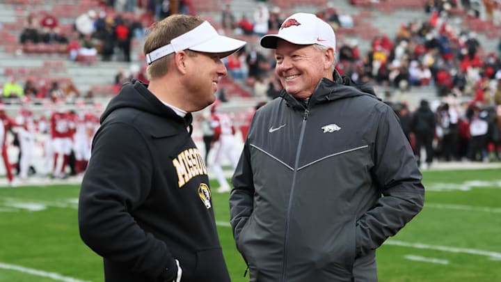 Nov 29, 2025; Fayetteville, Arkansas, USA; Arkansas Razorbacks interim head coach Bobby Petrino talks to Missouri Tigers head coach Eli Drinkwitz prior to a game against the at Donald W. Reynolds Razorback Stadium. Mandatory Credit: Nelson Chenault-Imagn Images