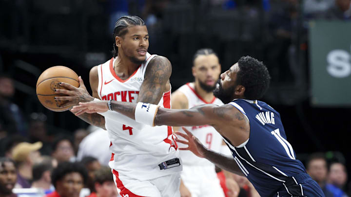 Oct 31, 2024; Dallas, Texas, USA;  Houston Rockets guard Jalen Green (4) looks to pass as Dallas Mavericks guard Kyrie Irving (11) defends during the second half at American Airlines Center. Mandatory Credit: Kevin Jairaj-Imagn Images