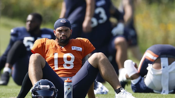 Aug 8, 2025; Lake Forest, IL, USA; Chicago Bears quarterback Caleb Williams (18) sits on the field during joint training camp practice with the Miami Dolphins ahead of Sunday's preseason opener. Mandatory Credit: Kamil Krzaczynski-Imagn Images
