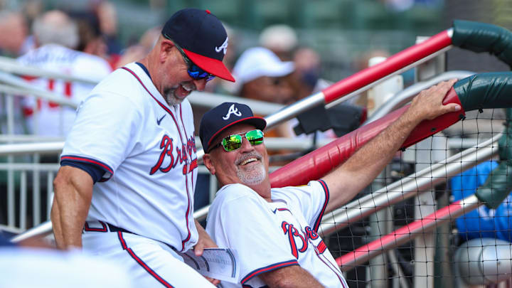 Sep 28, 2025; Cumberland, Georgia, USA; Atlanta Braves bench coach/infield coach Walt Weiss (4) and manager Brian Snitker (43) laugh in the dugout during the game against the Pittsburgh Pirates during the third inning at Truist Park. Mandatory Credit: Jordan Godfree-Imagn Images