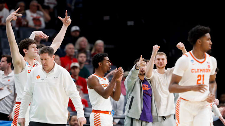Clemson players celebrate after Chauncey Wiggins (21) hit a three pointer 