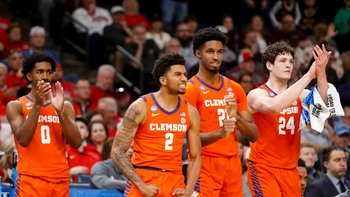 Clemson's Dillon Hunter (2) and other Clemson players react after a teammate made a free throw