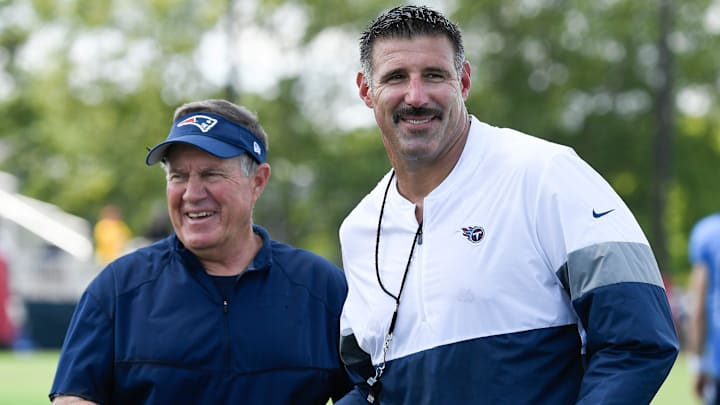 New England Patriots head coach Bill Belichick shares a laugh with Tennessee Titans head coach Mike
