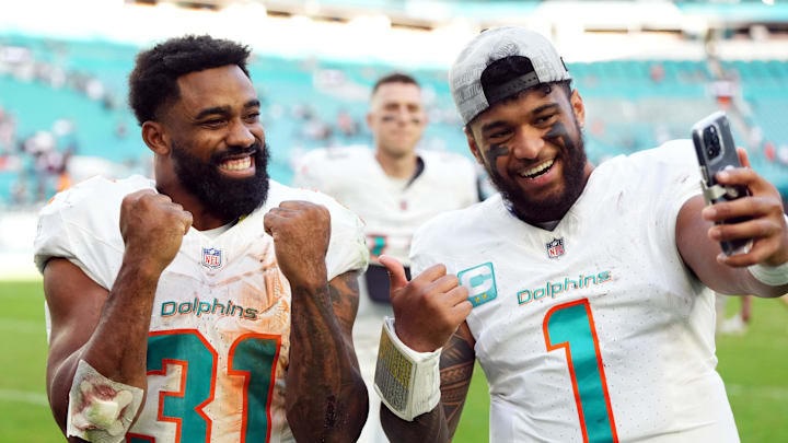 Dec 17, 2023; Miami Gardens, Florida, USA; Miami Dolphins quarterback Tua Tagovailoa (1) and running