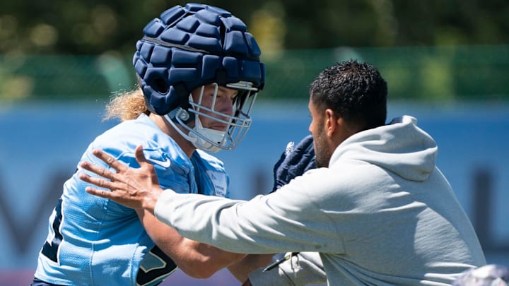 Tennessee Titans linebacker Derrek Tuszka (59) works with outside linebackers coach Ryan Crow during