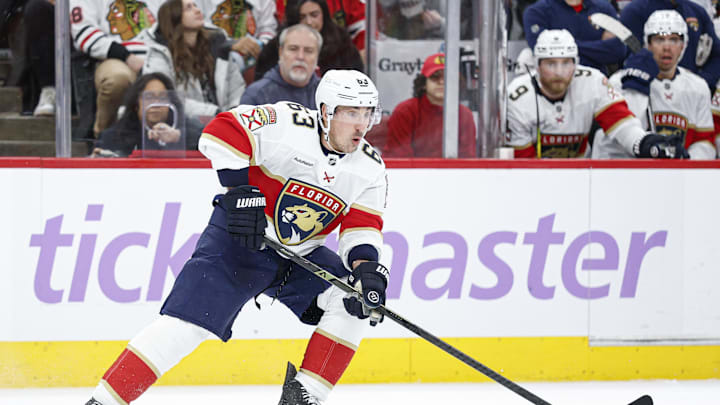Jan 25, 2026; Chicago, Illinois, USA; Florida Panthers left wing Brad Marchand (63) looks to pass the puck against the Chicago Blackhawks during the second period at United Center. Mandatory Credit: Kamil Krzaczynski-Imagn Images