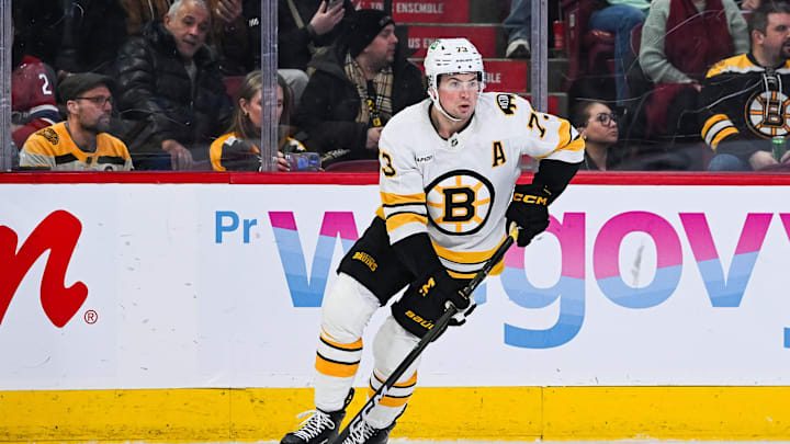 Mar 17, 2026; Montreal, Quebec, CAN; Boston Bruins defenseman Charlie McAvoy (73) plays the puck against the Montreal Canadiens during overtime at Bell Centre. Mandatory Credit: David Kirouac-Imagn Images