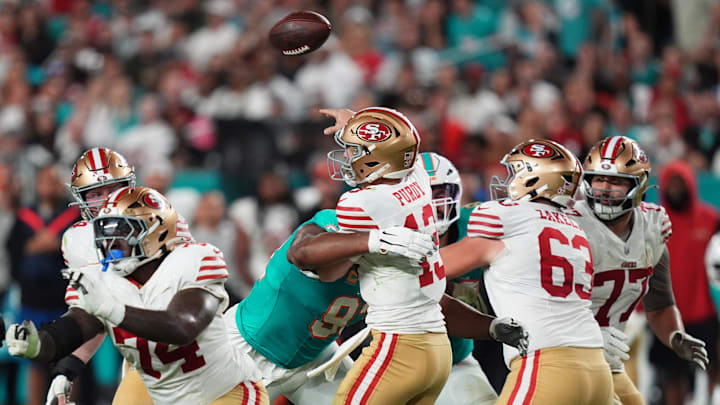 Dec 22, 2024; Miami Gardens, Florida, USA; Miami Dolphins defensive tackle Calais Campbell (93) hits San Francisco 49ers quarterback Brock Purdy (13) on the pass attempt during second half at Hard Rock Stadium. Mandatory Credit: Jasen Vinlove-Imagn Images